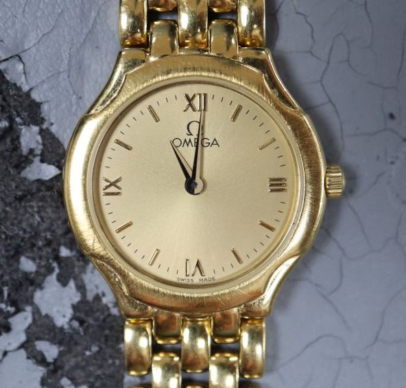 A ladys 1990s 18ct gold Omega quartz wrist watch on Omega 18ct gold bracelet,